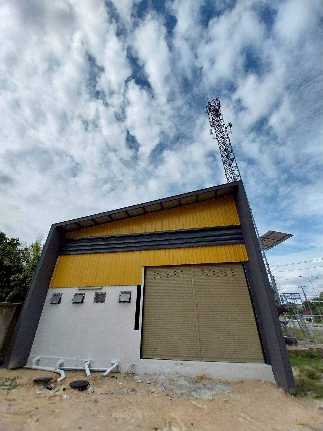 ด้านหน้าอาคารโกดังบ้านฉางพร้อมประตูม้วนขนาดใหญ่